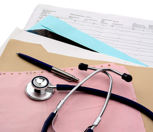 Photo of a stethoscope and a pen sitting on top of different colored folders